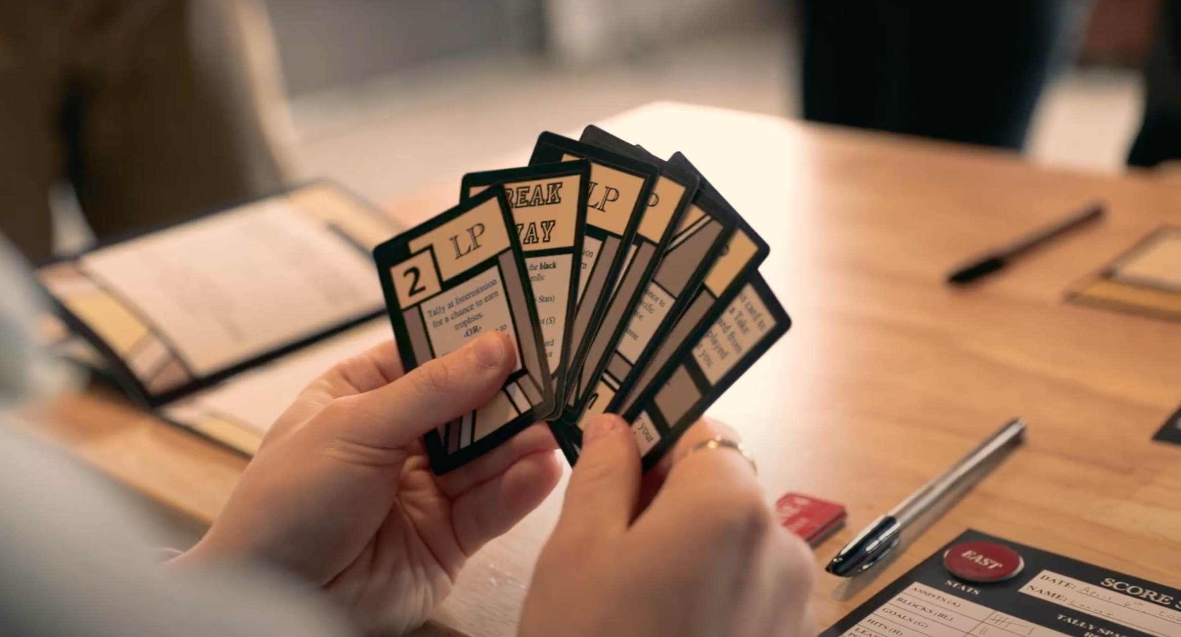 A player fans out their Hockey Hardware Game Cards.